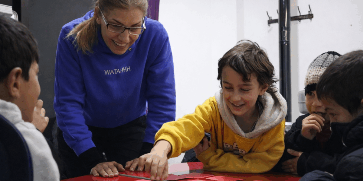 Salwa-with-her-tutor-and-friends-during-an-educational-activity-at-the-Fr-Frans-van-der-Lugt-Center-JRS-in-Al-Kafroun