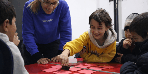 Salwa-with-her-tutor-and-friends-during-an-educational-activity-at-the-Fr-Frans-van-der-Lugt-Center-JRS-in-Al-Kafroun